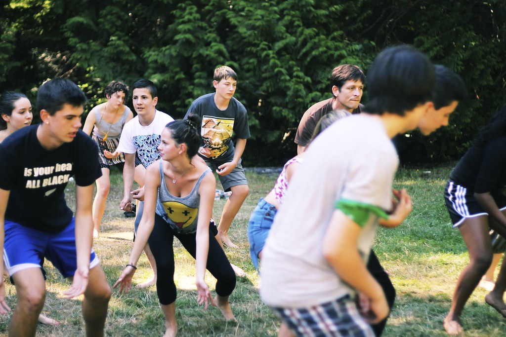 Youth playing a group game together on the grass